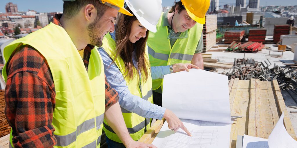 construction workers looking at blueprints on the jobsite